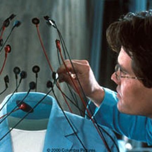 Josh Brolin hooks up sensors to test Kevin Bacons vital signs after the serum works.