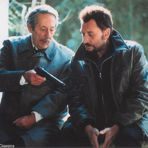 Bank robber (Johnny Hallyday, left) & retired school teacher (Jean Rochefort, right) each ponder the road not taken in Paramount Classics' award-winning Man on the Train, directed by Patrice Leconte. photo 17
