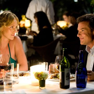 When Ray Embrey (Jason Bateman, right), a PR exec trying to clean up Hancock's image, brings the disgruntled superhero home, his wife, Mary (Charlize Theron, left), tries to convince him that Hancock is a lost cause in Columbia Pictures' Hancock. photo 11