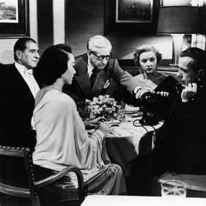 IN A LONELY PLACE, from left: Hadda Brooks (back to camera), Robert Warwick, Art Smith, Gloria Grahame, Humphrey Bogart, 1950