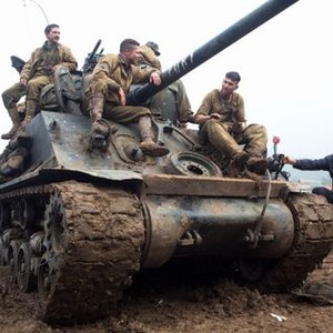 FURY, Shia LaBeouf (top left), Brad Pitt (front, at cannon), Jon Bernthal (right, on tank), Michael Pena (obscured), director David Ayer (right), on set, 2014. ph: Giles Keyte/©Columbia Pictures Entertainment