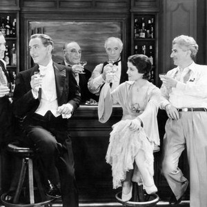 STRICTLY DISHONORABLE, from left: George Meeker, Paul Lukas, William Ricciardi, Lewis Stone, Sidney Fox, director John M. Stahl, drinking to each other's health after the last scene was shot, on set, 1931