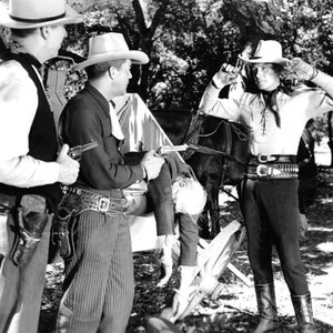 LAW OF THE SADDLE, second and third from left: Reed Howes, Robert Livingston, 1943