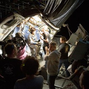 GRAVITY, Sandra Bullock (sitting, center), director Alfonso Cuaron (front, center), on set, 2013. ©Warner Bros. Pictures