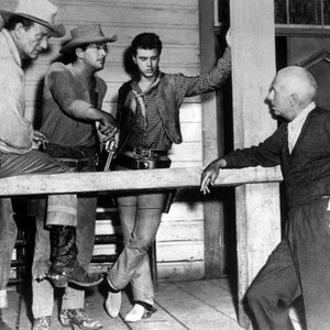 RIO BRAVO, John Wayne, Dean Martin, Rickey Nelson, director Howard Hawks on set, 1959