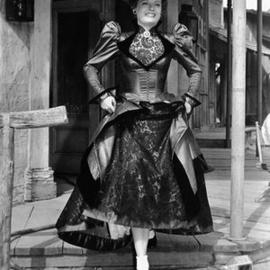 CAVE OF OUTLAWS, Alexis Smith, showing off her inaccurate footwear on-set, 1951