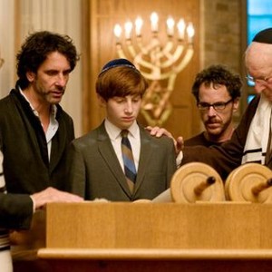 A SERIOUS MAN, director Joel Coen (left of center), Aaron Wolff (center), director Ethan Coen (right of center), on set, 2009. ph: Wilson Webb/©Focus Features