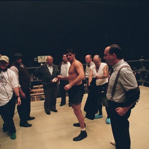RUSSELL CROWE (as Jim Braddock, center), PAUL GIAMATTI (as Joe Gould, far right), cast and crew on the set of "Cinderella Man."