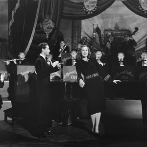 HOLLYWOOD CANTEEN, Rudolf Friml Jr. (conducting), Kitty Carlisle (standing at piano), 1944