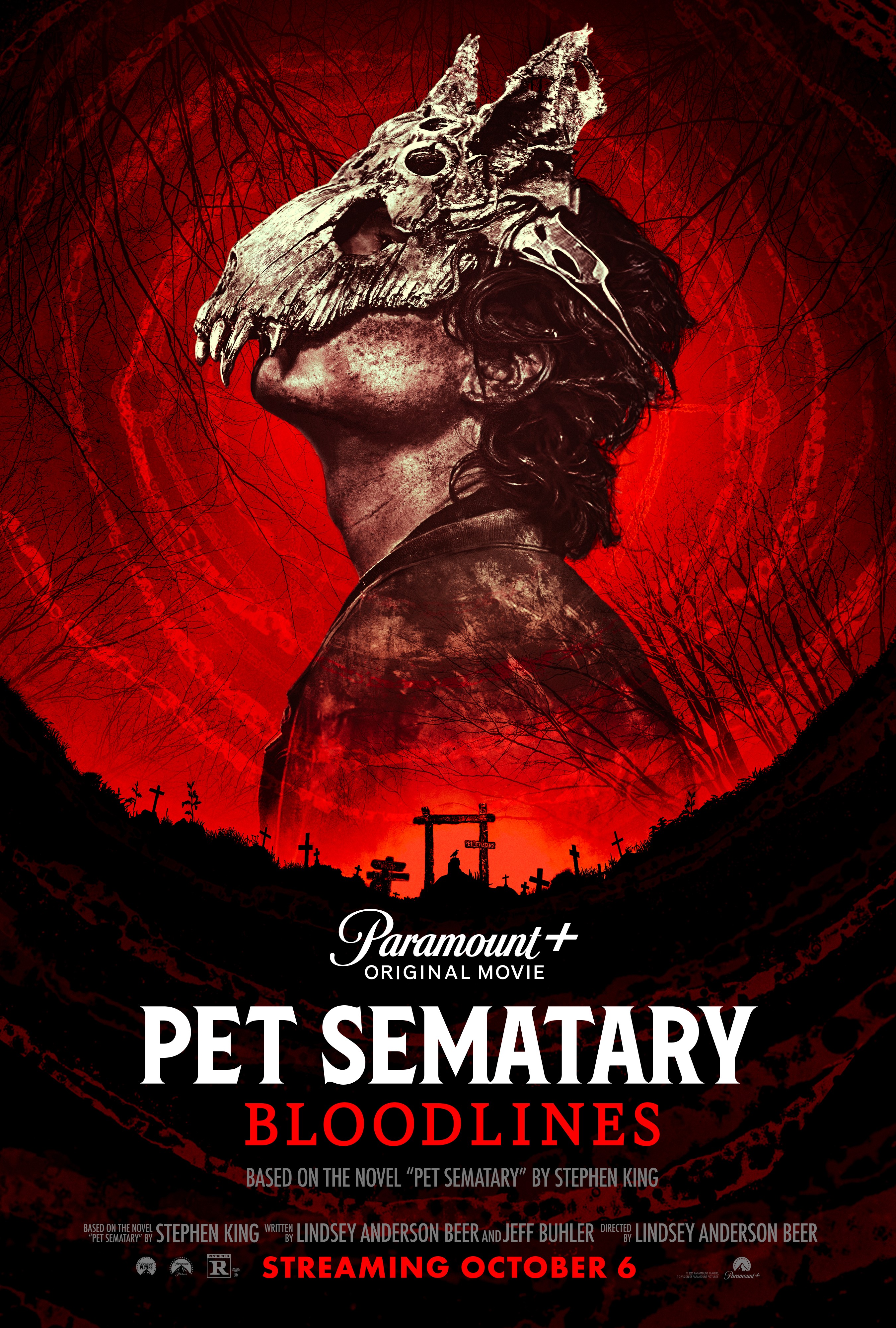 A red and black movie poster for Pet Sematary: Bloodlines, which includes a dark cemetery, spooky tree branches, and a boy wearing an animal skull mask.