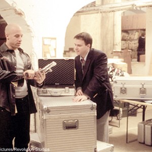 Agent "XXX" (Vin Diesel) inspects his weaponry options with the young NSA genius Toby (Michael Roof) in Columbia Pictures/Revolution Studios XXX. photo 2