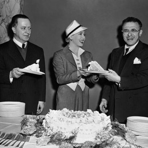 A LIFE OF HER OWN, Lana Turner (center) handing director George Cukor a piece of his birthday cake in celebration on set, 1950