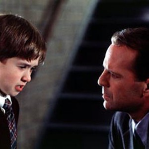 Eight-year-old Cole Sear (Haley Joel Osment, left) and Dr. Malcolm Crowe (Bruce Willis, right).