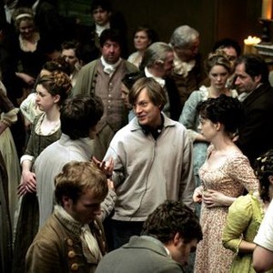 BECOMING JANE, James McAvoy (from behind, center left), director Julian Jarrold (center), Anne Hathaway as Jane Austen (right of center), on set, 2007. ©Miramax