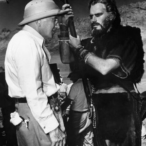 THE TEN COMMANDMENTS, from left: director Cecil B. De Mille, Charlton Heston on location at Mount Sinai, Egypt, 1956