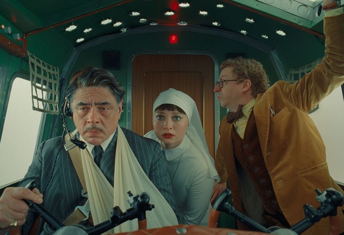 (L–R) Zsa-zsa (Benicio Del Toro), Liesl (Mia Threapleton), and Bjorn (Michael Cera) on a plane, in "The Phoenician Scheme. "(Focus Features/Universal Pictures)