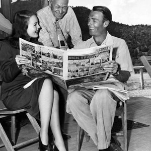 GUNFIGHTERS, from left: Dorothy Hart, Charley Grapewin, Randolph Scott, reading the comics between scenes, on location, Sedona Arizona, 1947