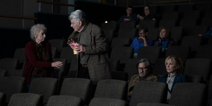 (L–R) Eunice Pearce (Marcia Jean Kurtz), Simon Pearce (Richard Benjamin, standing), Peter Pearce (Griffin Dunne), and Maria Pearce (Rosanna Arquette) go to the movies, in "Ex-Husbands." (Greenwich Entertainment)