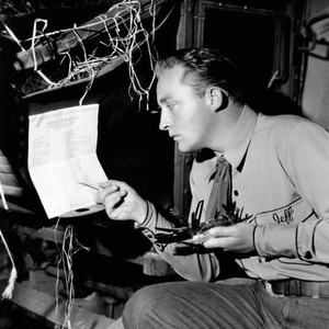 RHYTHM ON THE RANGE, Bing Crosby with his new multi-blade knife using a toothpick as a pointer on set, 1936