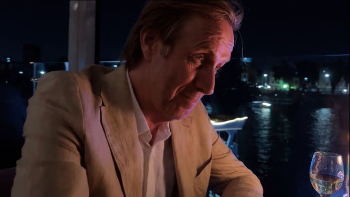 Sam (Rhys Ifans) seeks to bury the hatchet with his daughter over dinner in "Inheritance." (IFC Films/Everett Collection)