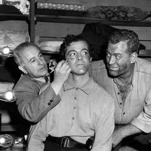 CANYON PASSAGE, Dana Andrews has bruises and blood applied by makeup man while fight scene opponant Ward Bond looks on, 1946