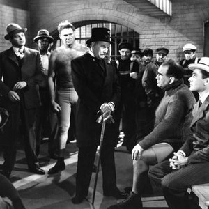 GENTLEMAN JIM, from left: Jack Carson (standing second from left, in suit), Wee Willie Davis (barechested), Wallis Clark (top hat), Ed Lewis (seated foreground, second from right), Errol Flynn (foreground far right), 1942