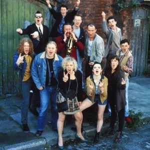 THE COMMITMENTS, (back) Felim Gormley, Dick Massey, (center) Jimmy Murphy (with trumpet), Kenneth McCluskey, Dave Finnegan, Michael Ahearne, (front) Glen Hansard, Andrew Strong, Angeline Ball, Bronagh Gallagher, Maria Doyle, Robert Arkins, 1991, TM & Copyr