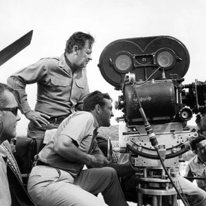 THE WILD BUNCH, director Sam Peckinpah (lower left), William Holden (standing), between scenes, on location, 1969
