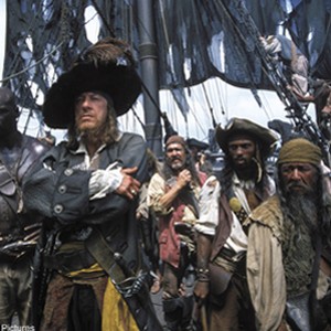 Wily Captain Barbossa (Geoffrey Rush, foreground) is flanked by his first mate, Bo'sun (Isaac C. Singleton, Jr., left) and other members of his motley crew.