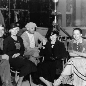 LAUGHING BOY, from left: Ramon Novarro, director W.S. Van Dyke (cap), visitor Myrna Loy, Lupe Velez on set, 1934