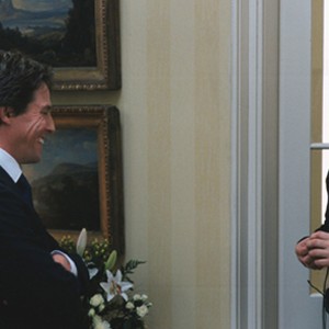 Screenwriter/Director RICHARD CURTIS with HUGH GRANT on the set of his romantic comedy Love Actually. photo 5