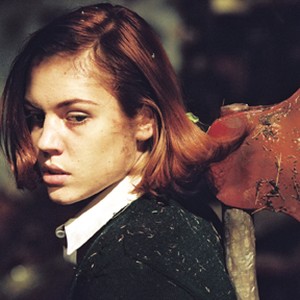 Heather (AGNES BRUCKNER) hides an ax behind herself in United Artists' horror THE WOODS. photo 12