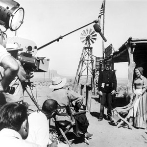 CHEYENNE AUTUMN, Richard Widmark, Carroll Baker, being directed by John Ford, on location in Monument Valley, UT, 1964.