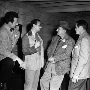 BELLE OF THE YUKON, costume designer Don Loper, producer William Goetz, director William A. Seiter, screenwriter James Edward Grant on set, 1944