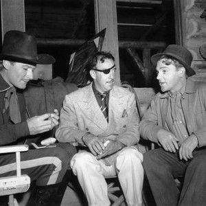 THEY DIED WITH THEIR BOOTS ON, from left, Errol Flynn, director Raoul Walsh, James Cagney, (visiting from set of THE BRIDE CAME C.O.D.), 1941