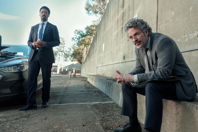 two men in suits next to the freeway on-ramp in Crime 101