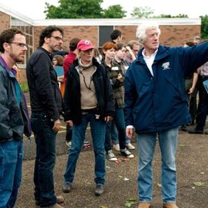 A SERIOUS MAN, foreground from left: writer/directors Ethan Coen, Joel Coen, first assistant director Betsy Magruder, cinematographer Roger Deakins, on set, 2009. ph: Wilson Webb/©Focus Features