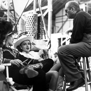 GIRL CRAZY, Judy Garland and Director Norman Taurog discussing scene on the set, 1943