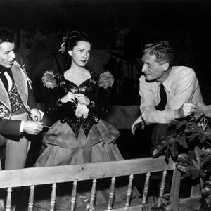 THE KISSING BANDIT, Frank Sinatra and Kathryn Grayson talk with director Laslo Benedeck on set before filming scene, 1948