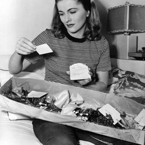 THE AFFAIRS OF SUSAN, Joan Fontaine on her first day of shooting receives a corsage from each of her leading men, 1945