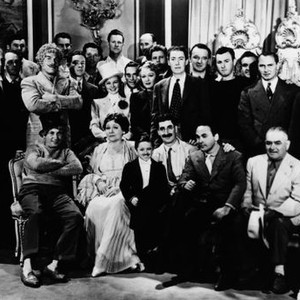 AT THE CIRCUS, cast and crew on set, seated from left: Harpo Marx, Margaret Dumont, Jerry Maren, Groucho Marx, director Edward Buzzell, standing front row from left: Barnett Parker, Nat Pendleton (arms folded), Florence Rice (top hat), Eve Arden, Kenny Bak
