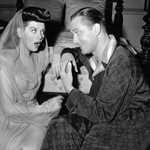 WHAT A WOMAN!, Rosalind Russell, being told a shocking joke by Brian Aherne, on-set, 1943
