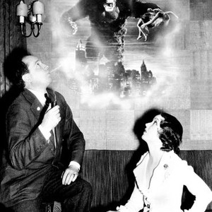 KING KONG, producer Merian C. Cooper, Fay Wray in awe of King Kong on the film poster, 1933