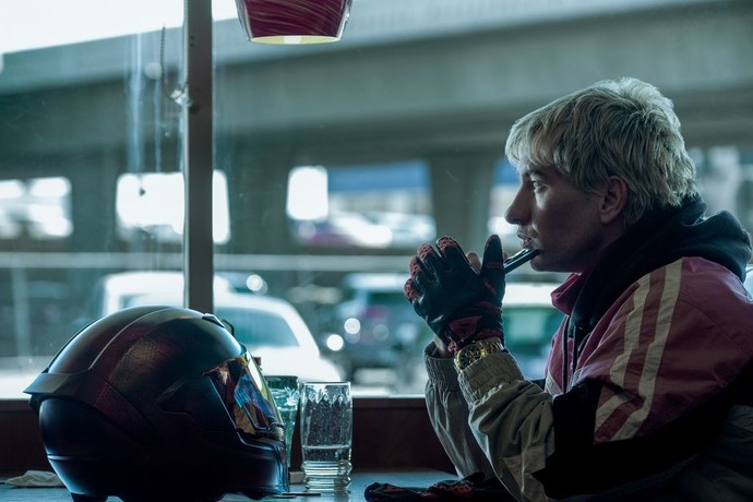 blond kid in red jacket with motorcycle helmet in Crime 101