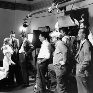 DEATH ON THE DIAMOND, from left: Madge Evans, Robert Young, David Landau, director Edward Sedgwick (cap), screenwriter Joseph Sherman (hand in pocket right) on set, 1934