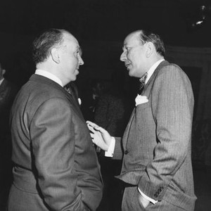 ROPE, from left: director Alfred Hitchcock, Noel Coward on set, 1948