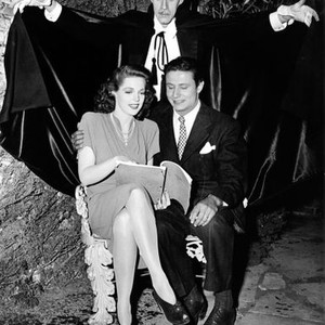HOUSE OF FRANKENSTEIN, John Carradine, looms over Anne Gwynne, & Peter Coe, during this candid on the set, 1944