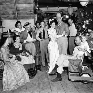 REMEMBER THE NIGHT, Elizabeth Patterson (left), Beulah Bondi (second left), Barbara Stanwyck (center), Fred MacMurray (right of center), director Mitchell Leisen (second right) and vistior, Barbara Burke (right), on set, 1940