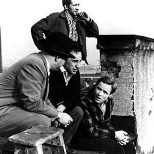 ON THE WATERFRONT, Director Elia Kazan (ctr), Marlon Brandon (r) on the set with Hoboken Director of Public Safety Arthur Marotta (l) and cinematographer Boris Kaufman (rear), 1954