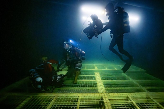 Film crew cameraman and stunt divers shooting on location in "Last Breath." (Focus Features)